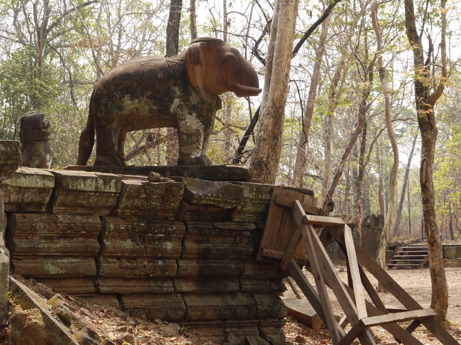 Stone elephant statue atop temple ruins